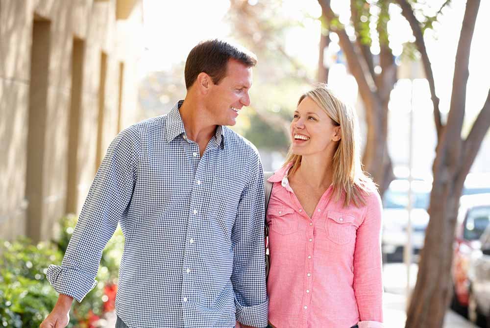 A man and woman smile at each other while enjoying things to do in San Antonio, Texas.
