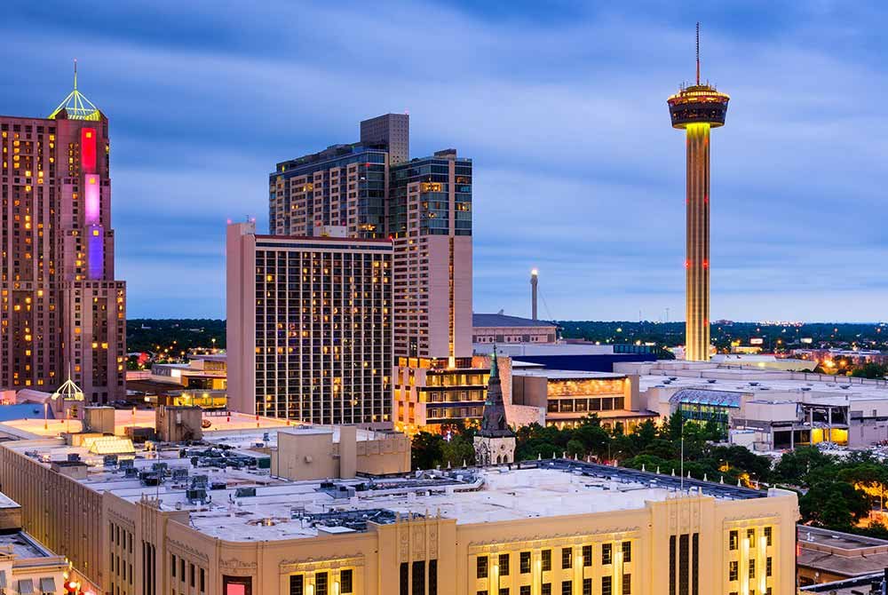 The San Antonio skyline at dusk, a top thing to do in San Antonio, Texas, featuring the Tower of the Americas and surrounding city buildings.