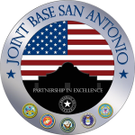 Official seal of Joint Base San Antonio, featuring the American flag over a silhouette of the Alamo, where one might enjoy birding in San Antonio, the motto “Partnership in Excellence,” and the emblems of the five military branches.